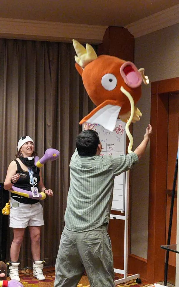 A contestant tossing a Magikarp plushie up in the air